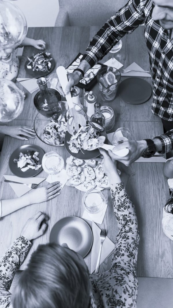 two-men-putting-tasty-dish-plate-women-little-girl